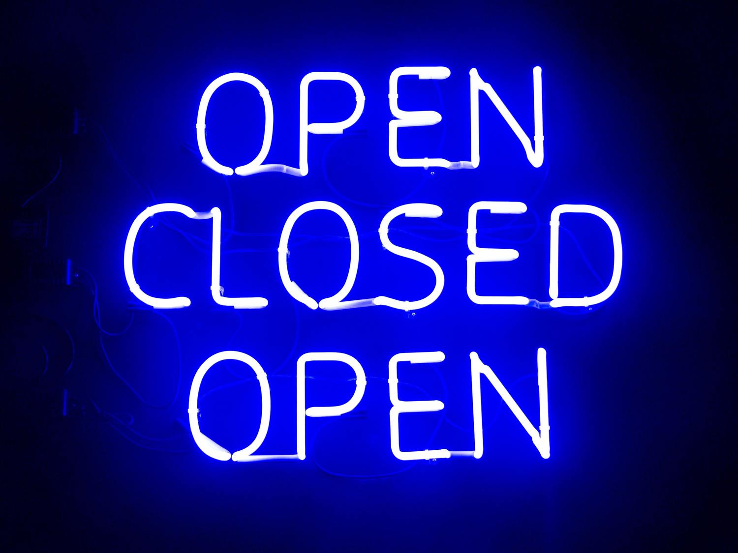 Neon-Schild mit den Worten „OPEN CLOSED OPEN“.