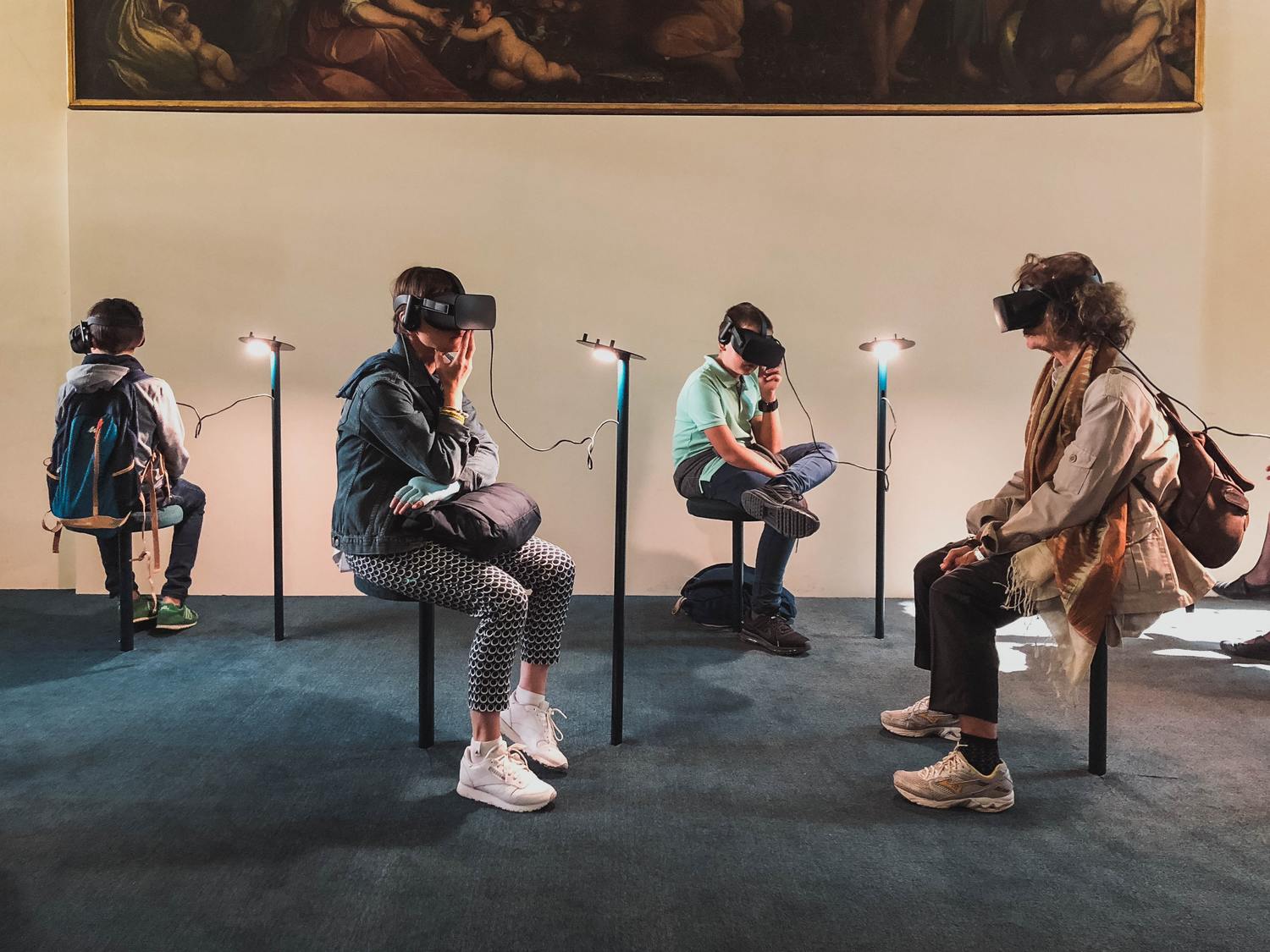 Personen sitzen mit VR-Brillen in einem Raum.