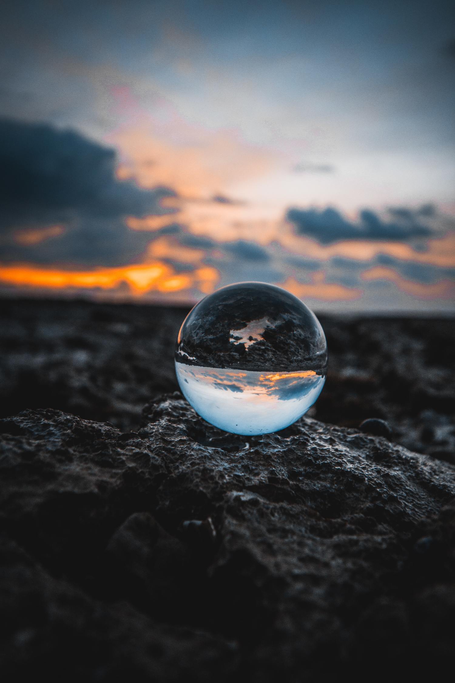 Glaskugel mit Spiegelung vor Sonnenuntergang.