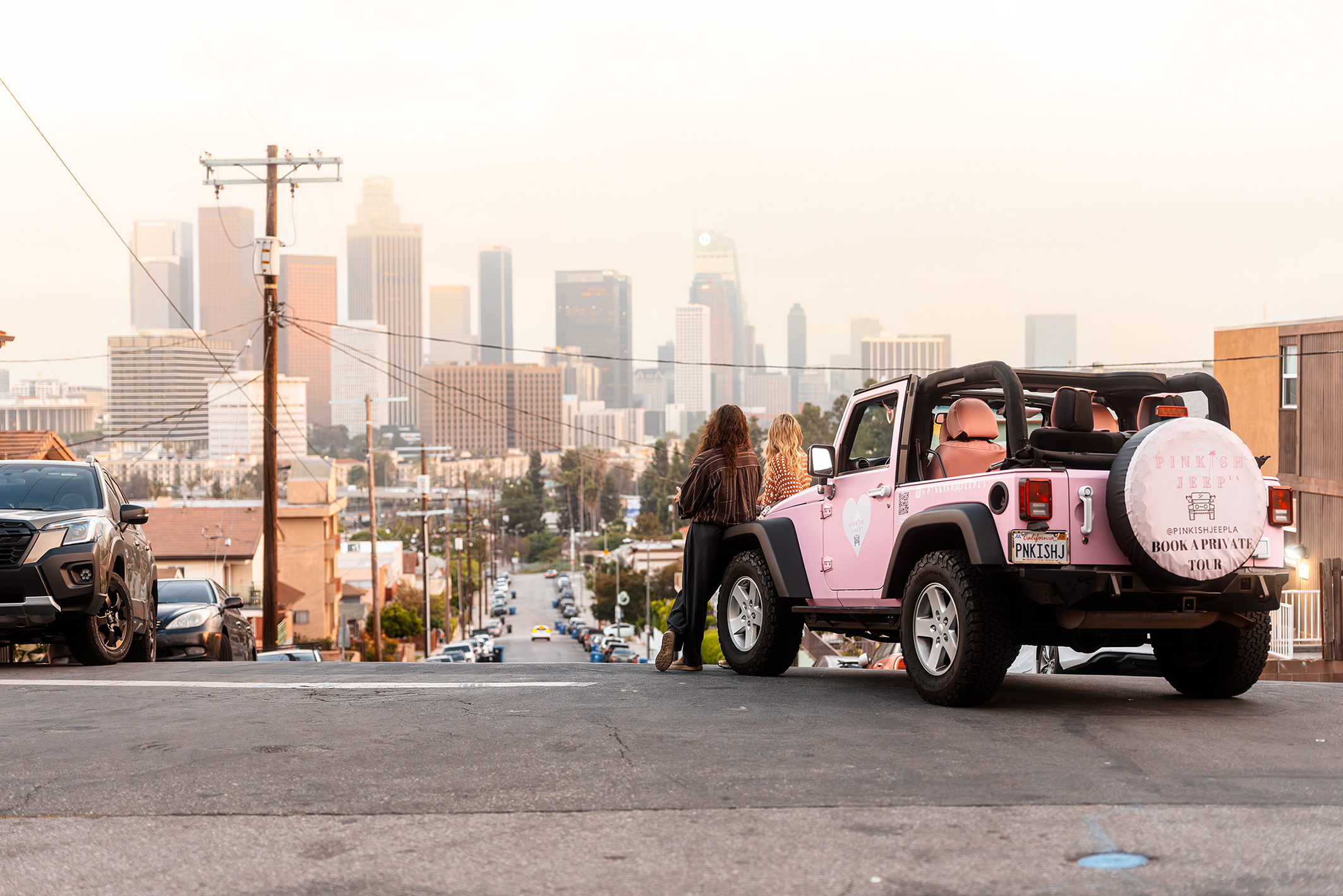 Tom und Bill Kaulitz sitzen in pinkem Jeep und schauen auf die Skyline von LA
