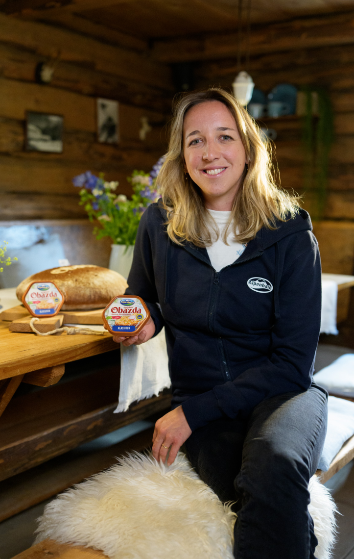 Biathletin Franziska Preuß mit einer Packung Obazda in der Hand