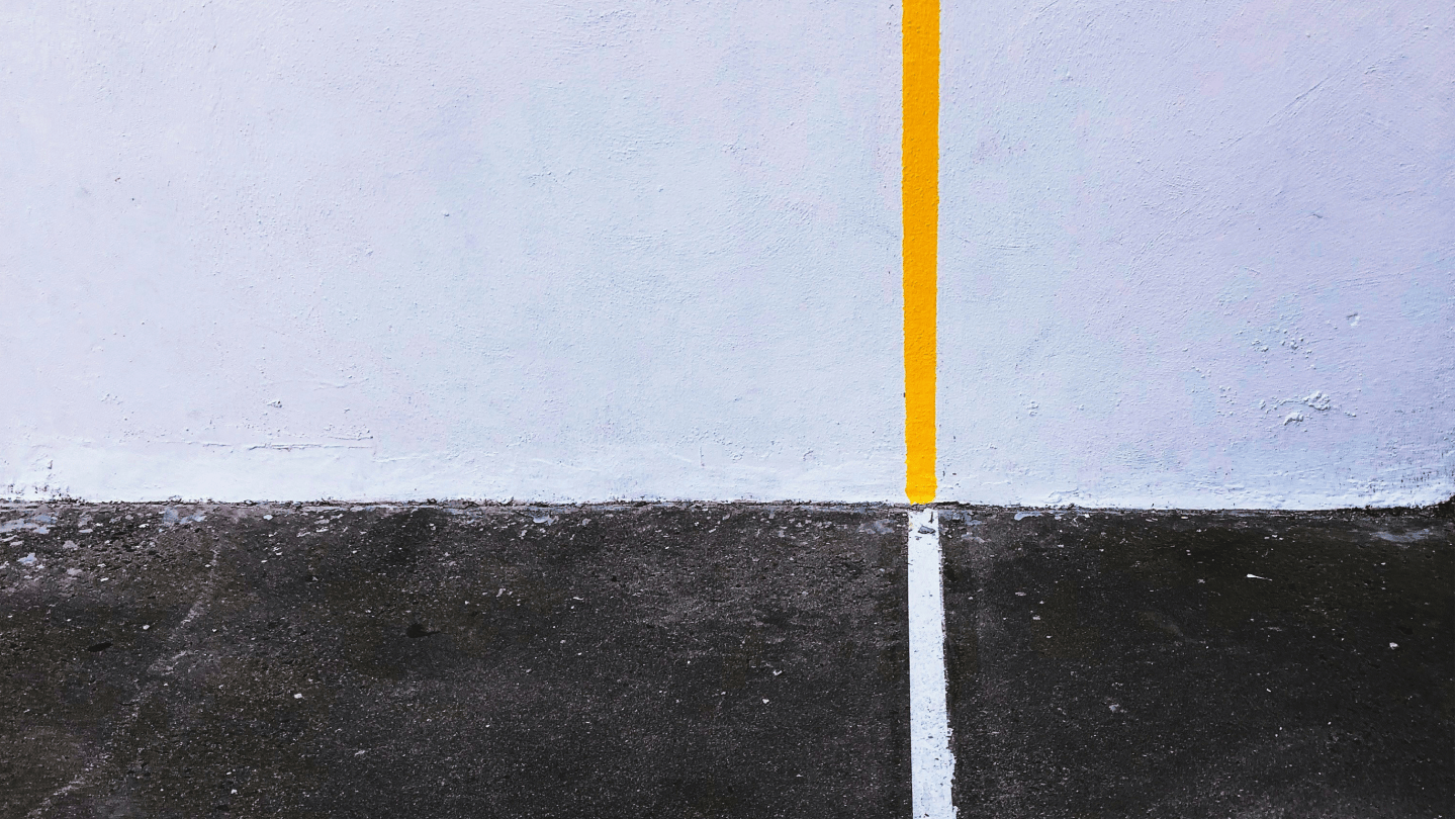 Eine weiße Linie die zu gelb wird auf einer grau weißen Wand